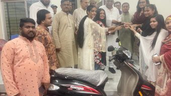 Home minister gives bikes, Scooty to students