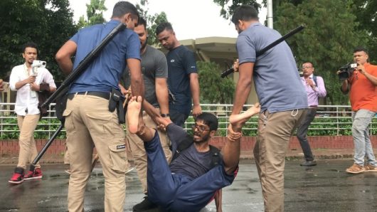 Plain clothe people dragging students where?